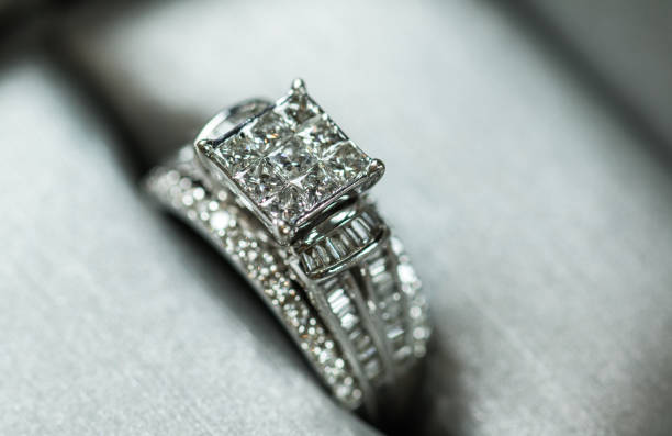 istock A diamond engagement ring in a box with glint/reflection. Shimmering princess-cut diamonds. 1048147098