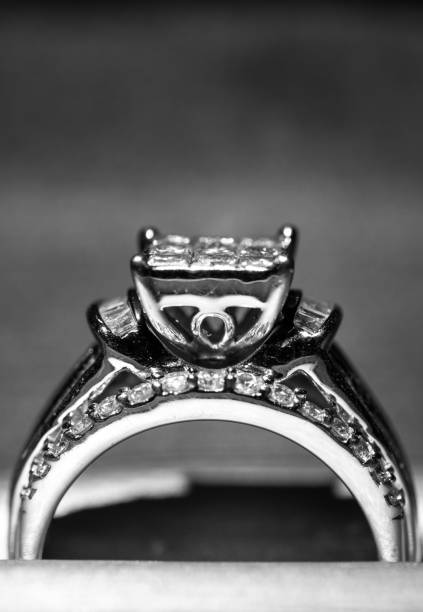 istock A diamond engagement ring in a box with glint/reflection. Shimmering princess-cut diamonds. 1048148066