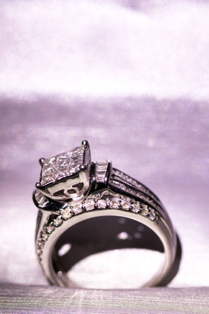 istock A diamond engagement ring in a box with glint/reflection. Shimmering princess-cut diamonds. 1048148110