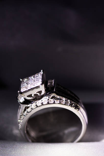 istock A diamond engagement ring in a box with glint/reflection. Shimmering princess-cut diamonds. 1048148124