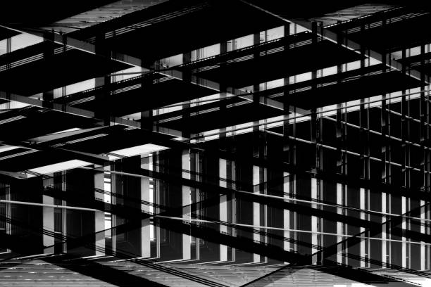 istock Backlit metal supporting structures in darkness. Computer graphic image of industrial architecture fragment in grunge technique. Abstract black and white background on the subject of construction industry. 1048148326