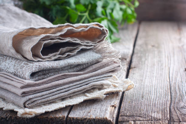 istock Clean beige kitchen linen towels on a wooden table, Horizontal, copy space 1048155892