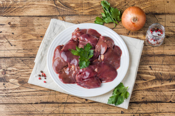 istock Fresh raw chicken liver on a plate. Wooden rustic background 1048170230