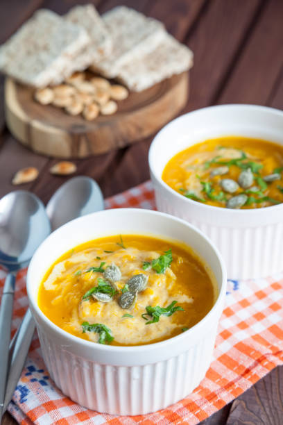 istock Pumpkins and Carrot Soup with Cream 1048171380