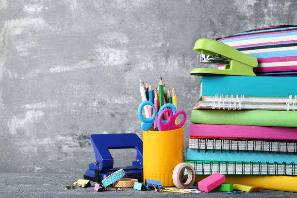 istock School supplies with books and notebooks on gray background 1048171556