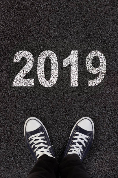 istock 2019 written on fresh asphalt with man's feet 1048178798