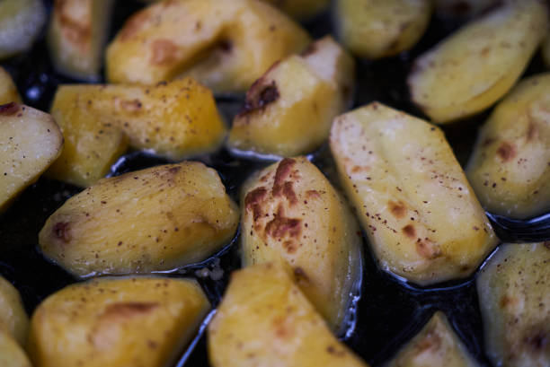 istock Baked fried potatoes on frying pan background, close-up 1048182658