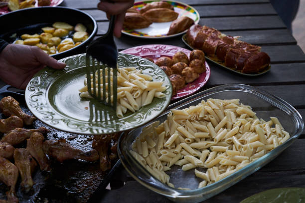 istock People at a party taking different food, outdoor 1048182804