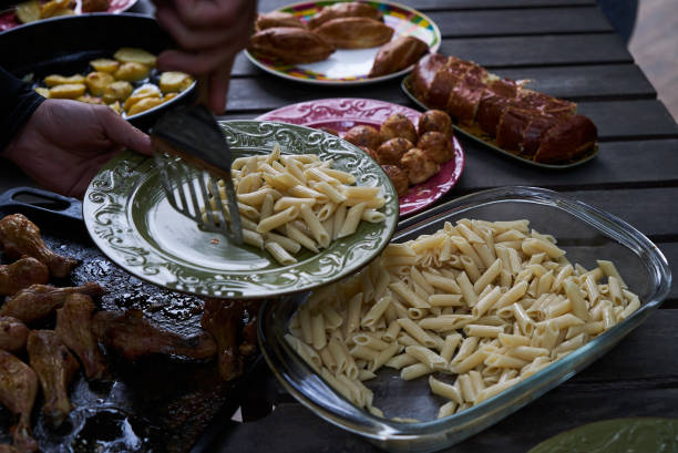 istock People at a party taking different food, outdoor 1048182808
