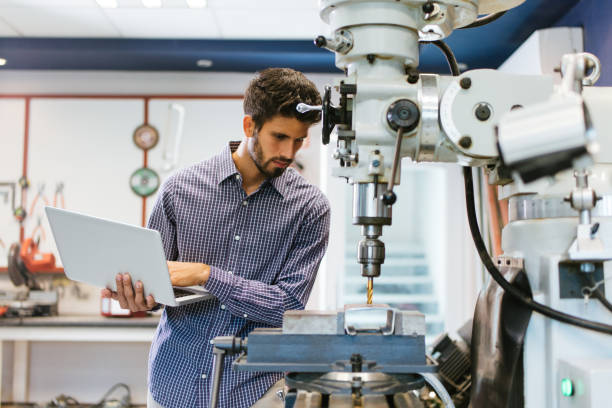 istock Latin engineer working on drill with laptop in hand 1048191140