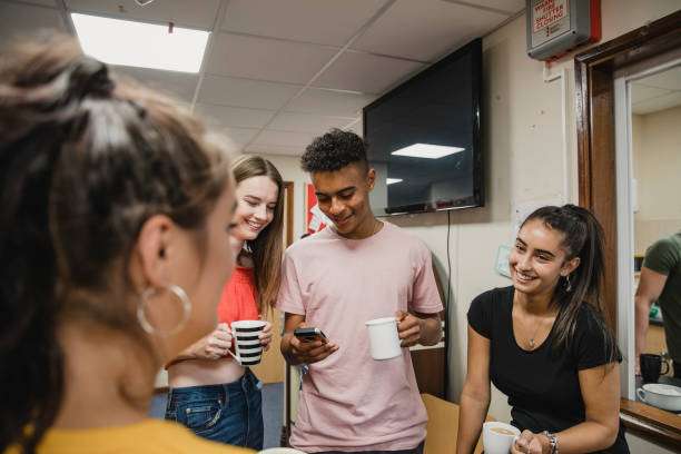 teenagers relaxing at youth club - youth organization imagens e fotografias de stock