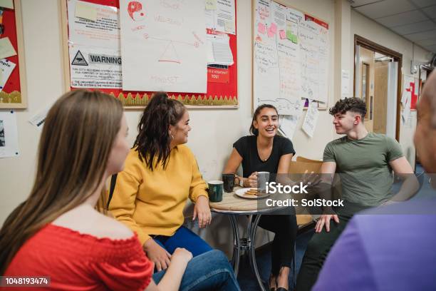 Teenagers Relaxing With Tea At Youth Club Stock Photo - Download Image Now - Teenager, Community, Discussion