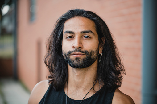 Close up portrait of a mid-adult mixed race man.