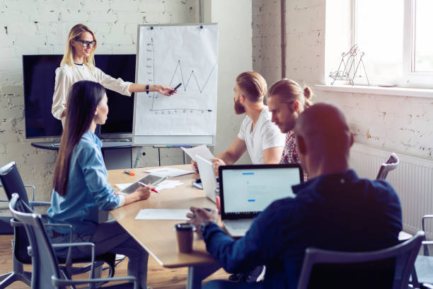 istock Working hard to win. Businesswoman conducting a business presentation using flipchart while working in the creative office. 1048202242