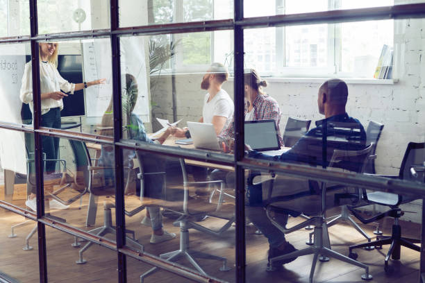 istock Working hard to win. Businesswoman conducting a business presentation using flipchart while working in the creative office. 1048202250
