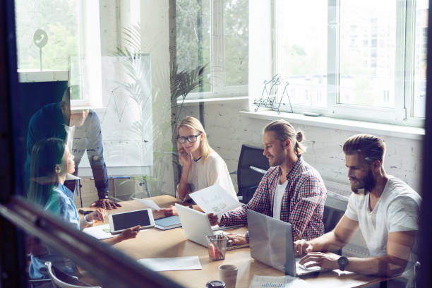 istock Full concentration at work. Corporate team working colleagues working in modern office. 1048202352