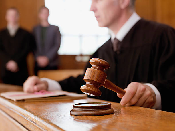 Judge holding gavel in courtroom  court room stock pictures, royalty-free photos & images