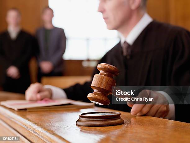 Judge Holding Gavel In Courtroom Stock Photo - Download Image Now - Courthouse, Judge - Law, Courtroom