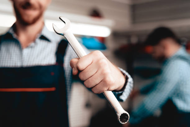 istock Auto Mechanic Posing With Wrench. Service Station. 1048213000