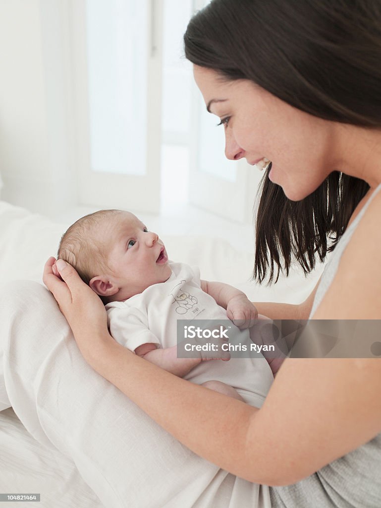 Smiling mother holding baby in lap  Baby - Human Age Stock Photo