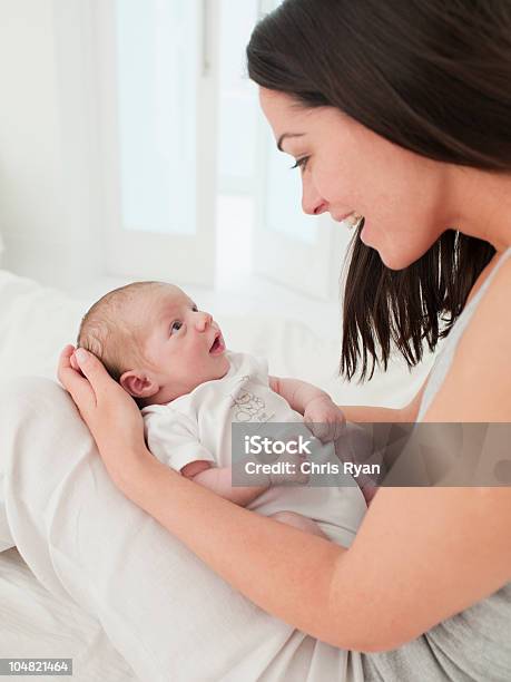 Smiling Mother Holding Baby In Lap Stock Photo - Download Image Now - Baby - Human Age, Mother, Newborn