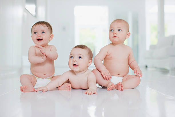 Smiling babies on floor  3 6 months stock pictures, royalty-free photos & images