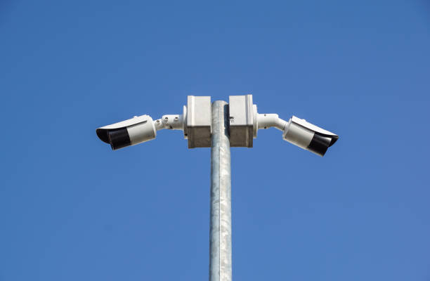 istock CCTV surveillance security camera on a black pole with blue sky background 1048216200