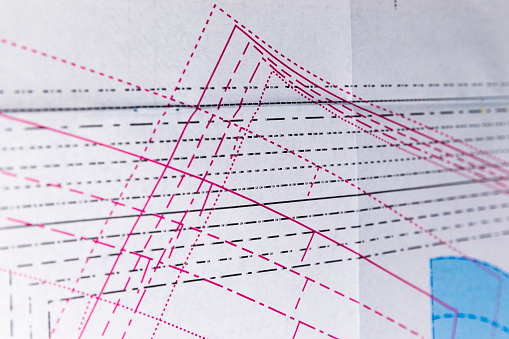 Red markings on paper for fabric pattern.