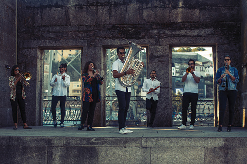 Group of musicians (Jazz band) play music in the old Porto downtown, Portugal.