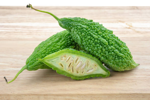 istock bitter gourds on wooden background 1048218400