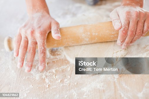 istock Close up of woman rolling dough with rolling pin 104821862