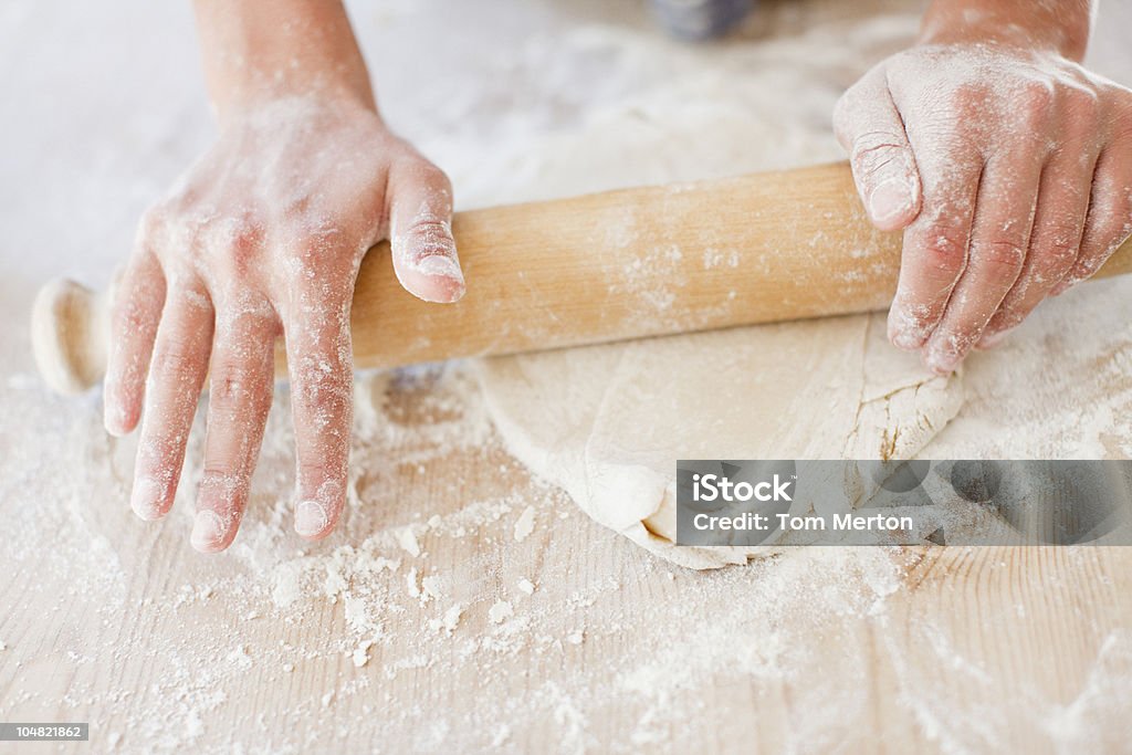 Close up of woman rolling dough with rolling pin  Dough Stock Photo
