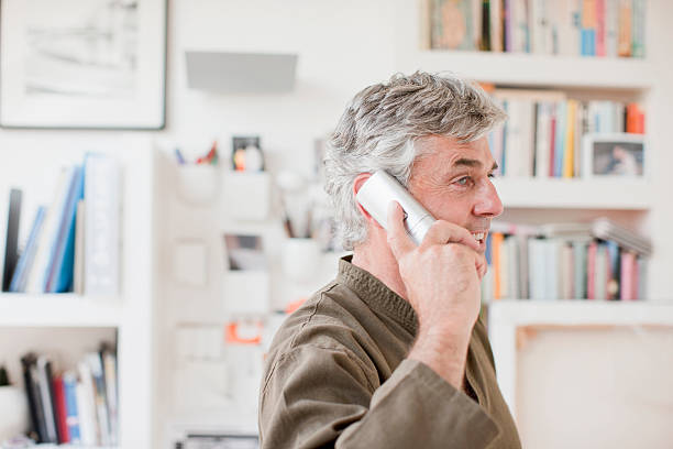 Man talking on telephone in office  cordless phone stock pictures, royalty-free photos & images