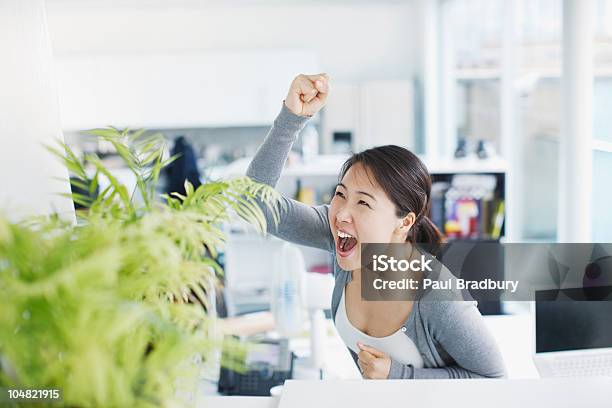 Eccitato Donna Daffari Celebrando In Ufficio - Fotografie stock e altre immagini di Incitare - Incitare, Donne, Ufficio