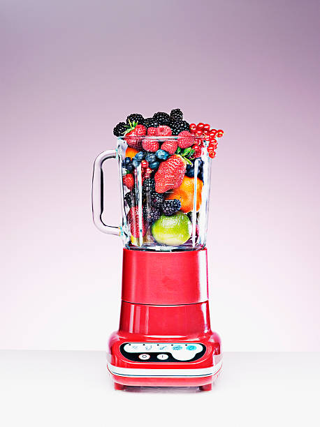 varietà di frutta nel frullatore piena - blender foto e immagini stock