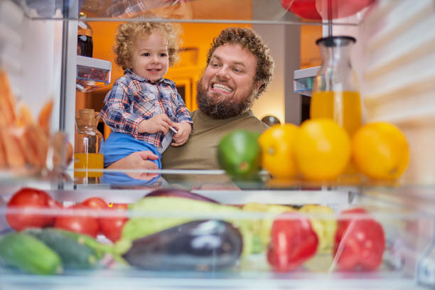 istock Father and son standing looking something to eat at night. 1048222948