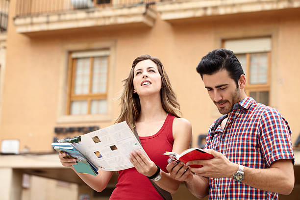 Young couple looking at sights Elche, Spain guidebook stock pictures, royalty-free photos & images
