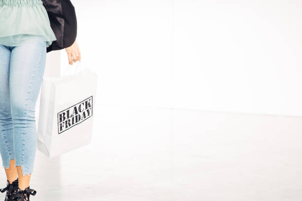 istock Girl holds black friday shopping bag 1048231352