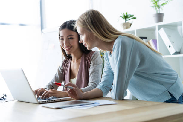 istock Two female colleagues in office working together. 1048233990