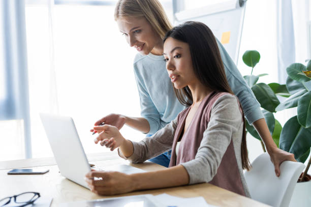 istock Two female colleagues in office working together. 1048234024