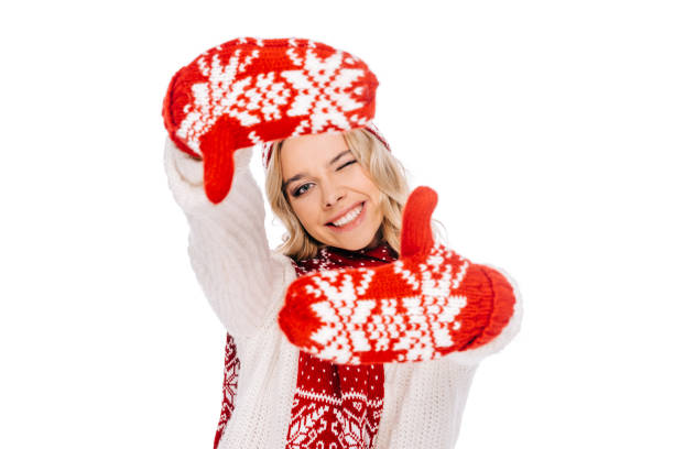 istock happy young woman in red mittens making hand frame isolated on white 1048237270
