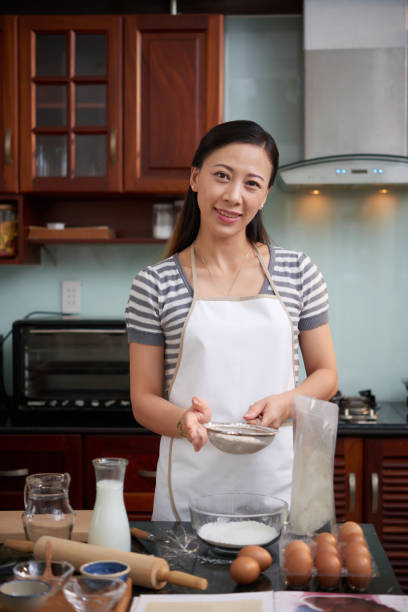 istock Cheerful Woman Making Cookies 1048238198