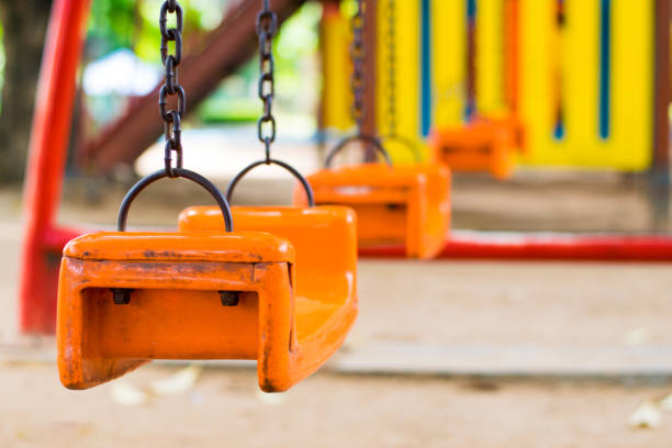 istock colorful swing in playground park 1048243566
