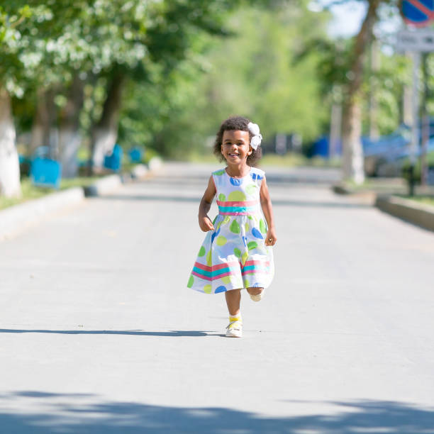 istock Black girl runs on the asphalt. 1048244760