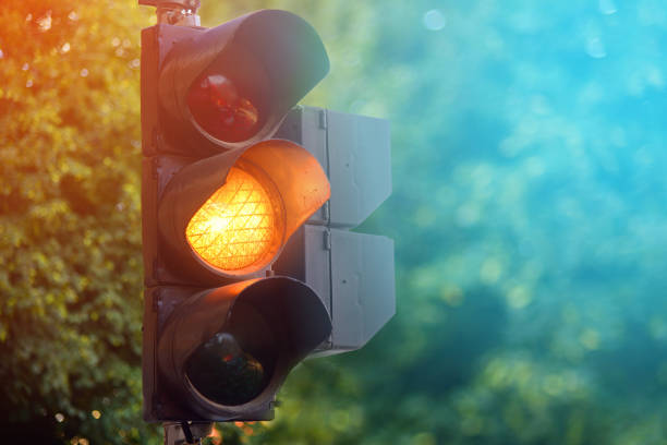 Yellow light of traffic lights in summer city Yellow light of traffic lights in summer city car street blue night stock pictures, royalty-free photos & images