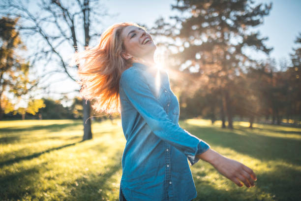 istock Woman enjoying outdoors at sunset 1048245230