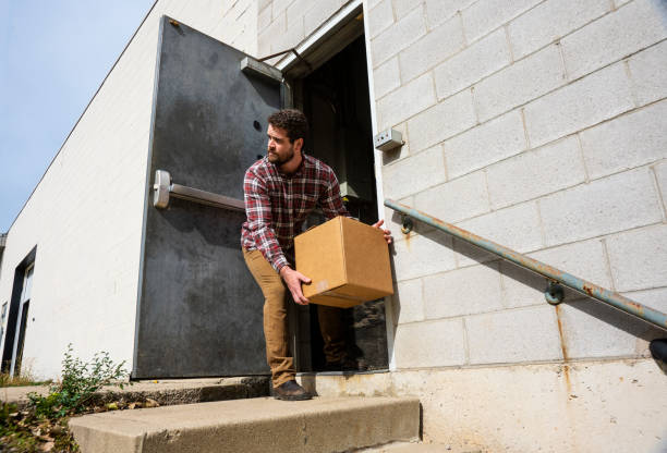 An industrial warehouse employee stealing stock photo