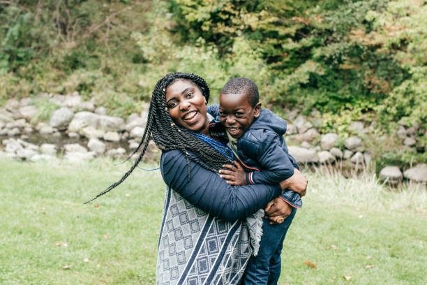 istock Mom and son having fun in the park 1048250002