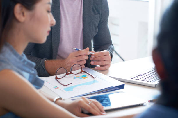 istock Discussing financial report at meeting 1048252864