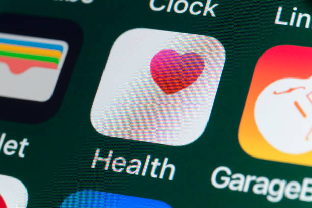 Health, Wallet, GarageBand and other Apps on iPhone screen London, UK - July 31, 2018: The buttons of the Apple health app Health, surrounded by Wallet, GarageBand, Clock and other apps on the screen of an iPhone. pedometer photos stock pictures, royalty-free photos & images